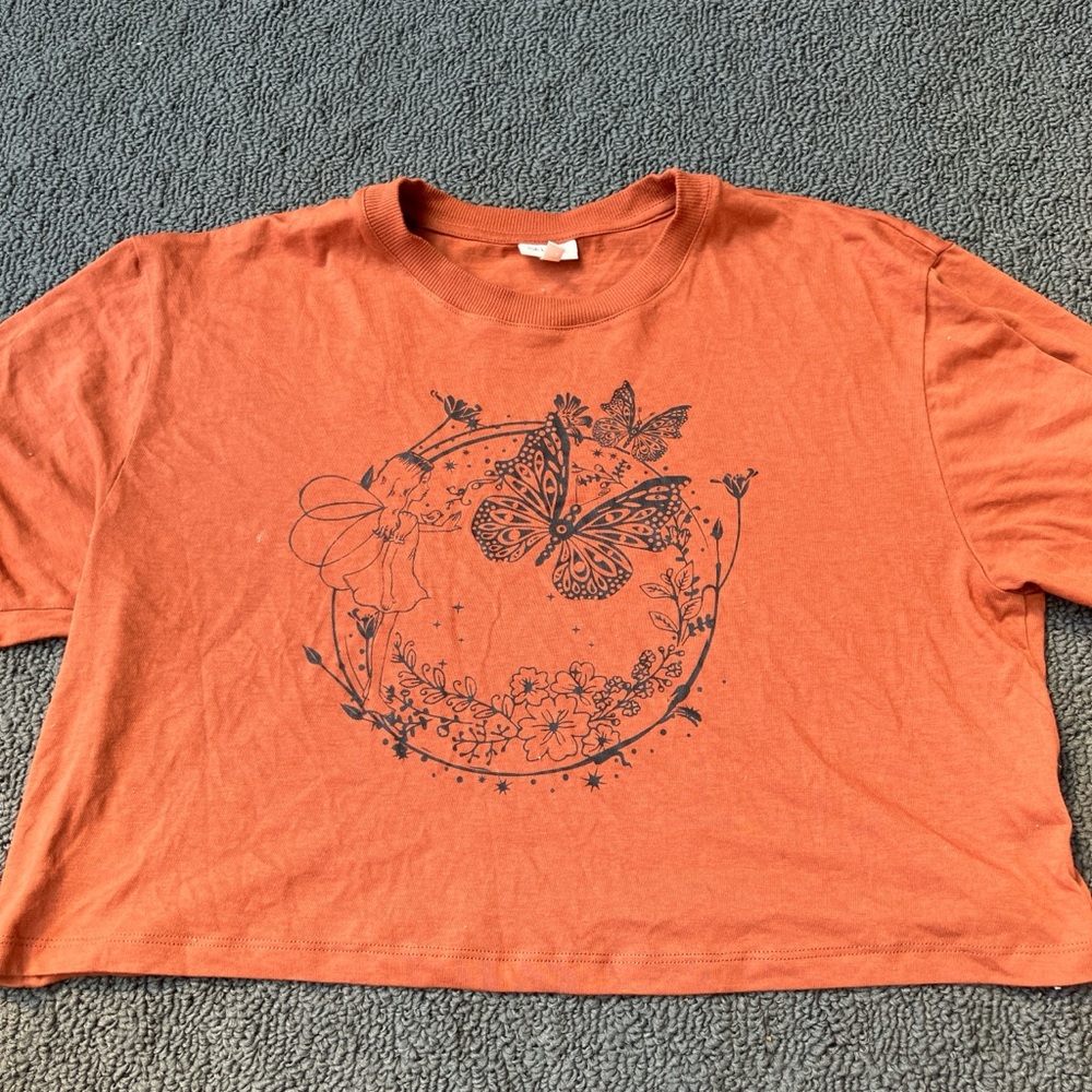 Orange waist length shirt with fairy design
